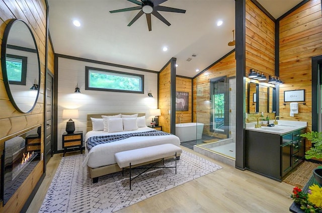 105 S Spruce Trl, Broken Bow, OK 74728 - bedroom with wood walls, light wood-style floors, and lofted ceiling