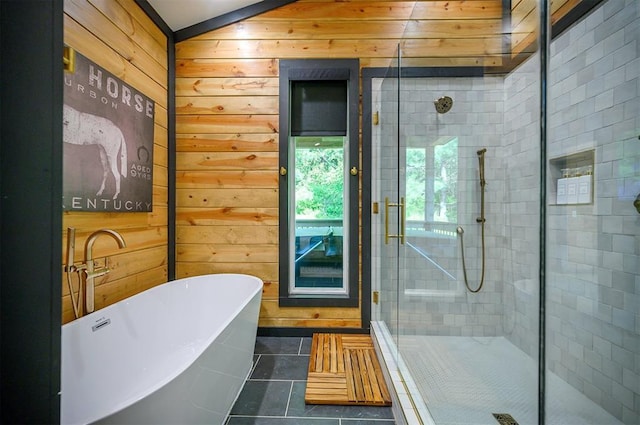 105 S Spruce Trl, Broken Bow, OK 74728 - full bathroom featuring wood walls, a soaking tub, tile patterned floors, and a stall shower
