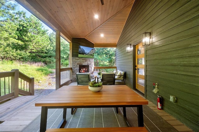 105 S Spruce Trl, Broken Bow, OK 74728 - wooden deck featuring an outdoor stone fireplace and outdoor dining area