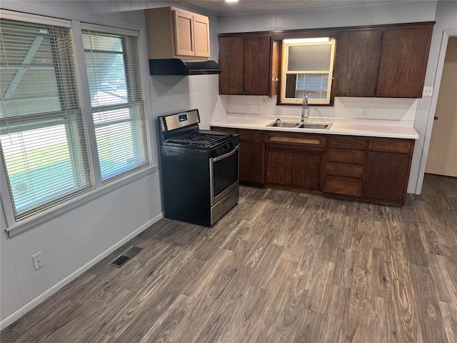 818 W Watts St, El Reno, OK 73036 - kitchen featuring stainless steel gas stove, ventilation hood, dark wood-type flooring, and light countertops