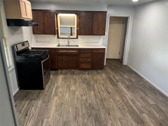 818 W Watts St, El Reno, OK 73036 - kitchen with stainless steel gas range oven, exhaust hood, and dark wood finished floors