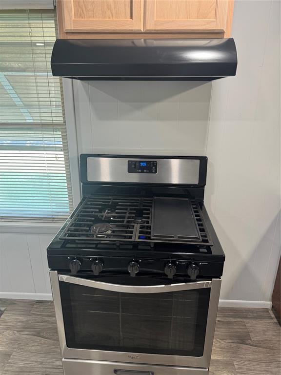 818 W Watts St, El Reno, OK 73036 - kitchen view of stainless steel range with gas cooktop, ventilation hood, and wood finished floors