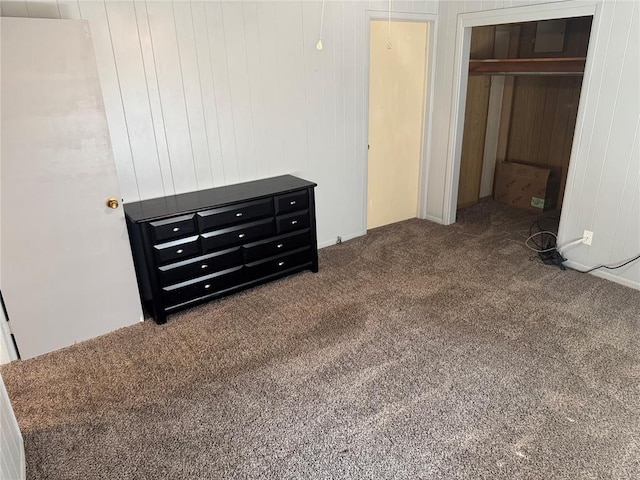 818 W Watts St, El Reno, OK 73036 - unfurnished bedroom featuring carpet flooring, wooden walls, and a closet
