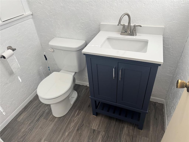 818 W Watts St, El Reno, OK 73036 - bathroom featuring a textured wall, vanity, and wood finished floors