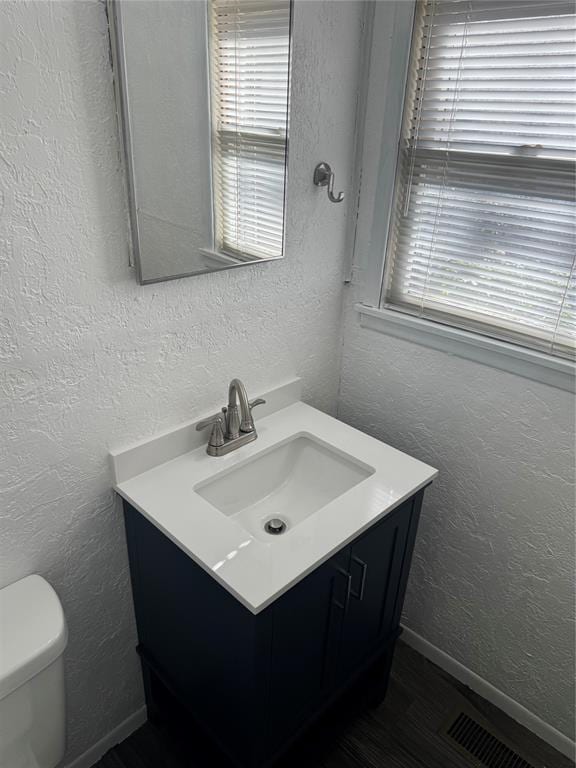 818 W Watts St, El Reno, OK 73036 - bathroom featuring vanity and a textured wall