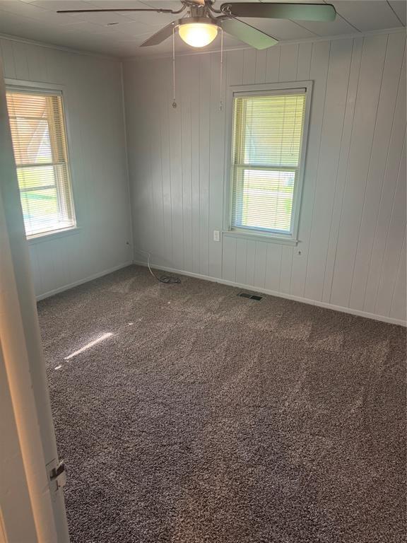 818 W Watts St, El Reno, OK 73036 - carpeted empty room with a ceiling fan