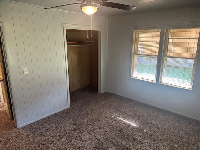 818 W Watts St, El Reno, OK 73036 - unfurnished bedroom with carpet flooring, a closet, ceiling fan, and wood walls