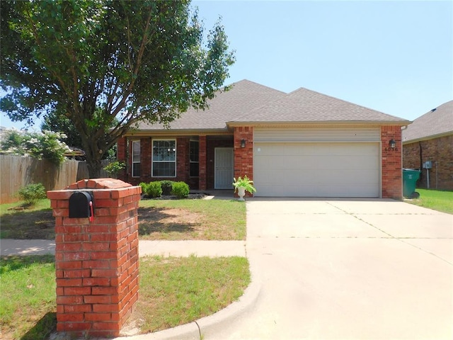 6036 SE 66th St, Oklahoma City, OK 73135 - view of front of property with an attached garage, concrete driveway, and brick siding