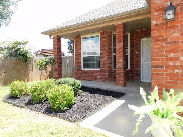 6036 SE 66th St, Oklahoma City, OK 73135 - entrance to property featuring a shingled roof, brick siding, and a porch