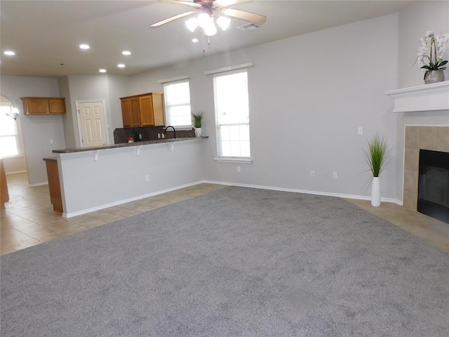 6036 SE 66th St, Oklahoma City, OK 73135 - unfurnished living room with ceiling fan, recessed lighting, a fireplace, and light carpet
