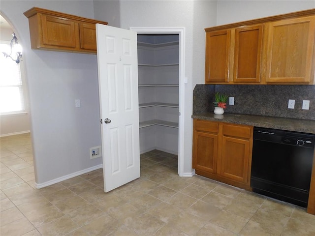 6036 SE 66th St, Oklahoma City, OK 73135 - kitchen featuring dishwasher, brown cabinets, dark countertops, arched walkways, and backsplash