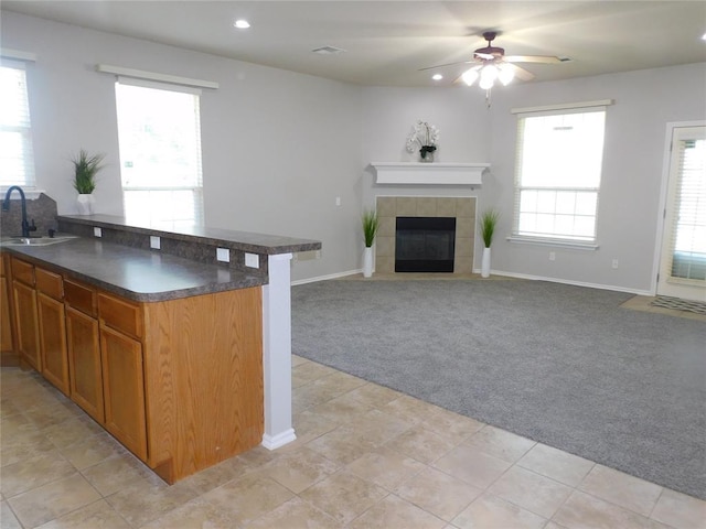 6036 SE 66th St, Oklahoma City, OK 73135 - kitchen with light carpet, dark countertops, brown cabinetry, a ceiling fan, and recessed lighting