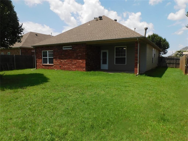 6036 SE 66th St, Oklahoma City, OK 73135 - rear view of property featuring a fenced backyard, roof with shingles, and brick siding