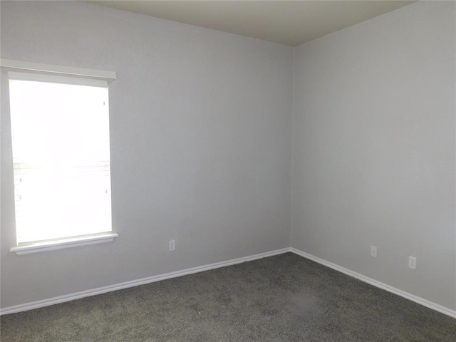 6036 SE 66th St, Oklahoma City, OK 73135 - spare room featuring dark colored carpet and baseboards