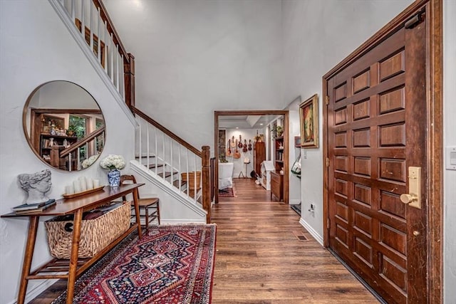 1601 Hazelhurst, Edmond, OK 73013 - entrance foyer featuring a high ceiling, wood finished floors, and stairway