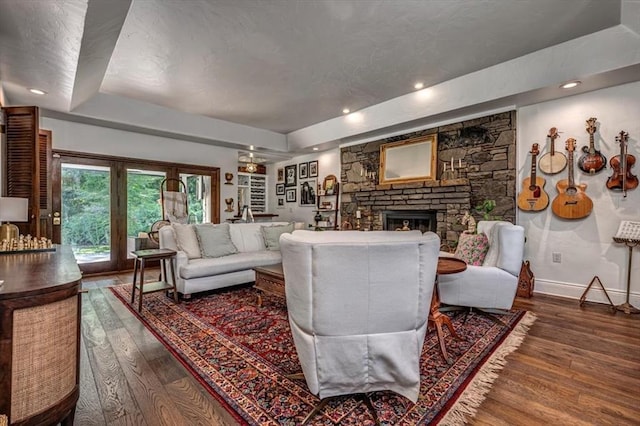 1601 Hazelhurst, Edmond, OK 73013 - living room with wood finished floors, a fireplace, and a raised ceiling
