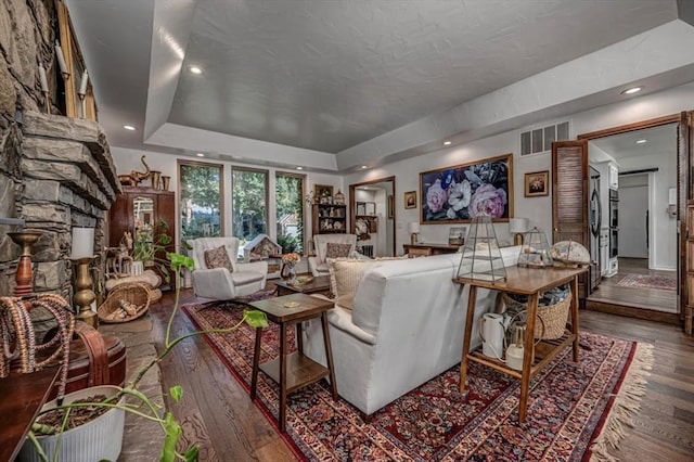 1601 Hazelhurst, Edmond, OK 73013 - living room featuring wood finished floors, a raised ceiling, and recessed lighting