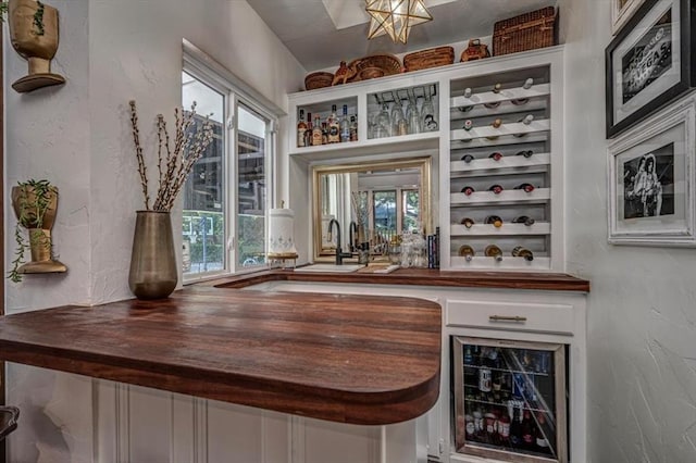 1601 Hazelhurst, Edmond, OK 73013 - indoor wet bar with wine cooler and a textured wall