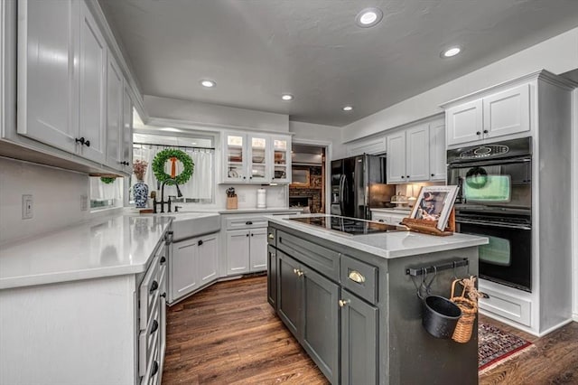 1601 Hazelhurst, Edmond, OK 73013 - kitchen with black appliances, gray cabinets, light countertops, recessed lighting, and dark wood-style flooring
