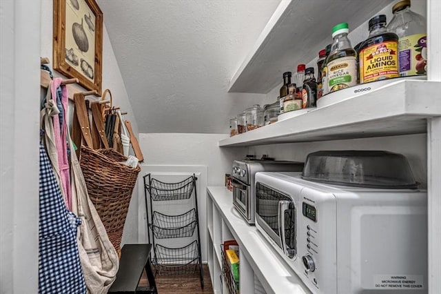 1601 Hazelhurst, Edmond, OK 73013 - laundry room featuring washing machine and clothes dryer, wood finished floors, and a textured wall