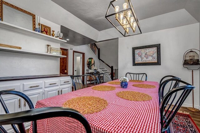 1601 Hazelhurst, Edmond, OK 73013 - dining area featuring stairs, wood finished floors, and a chandelier