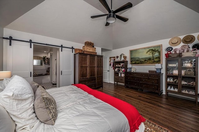 1601 Hazelhurst, Edmond, OK 73013 - bedroom with a barn door, wood finished floors, lofted ceiling, connected bathroom, and a ceiling fan