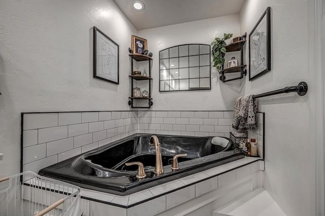 1601 Hazelhurst, Edmond, OK 73013 - bathroom featuring a garden tub and a textured wall