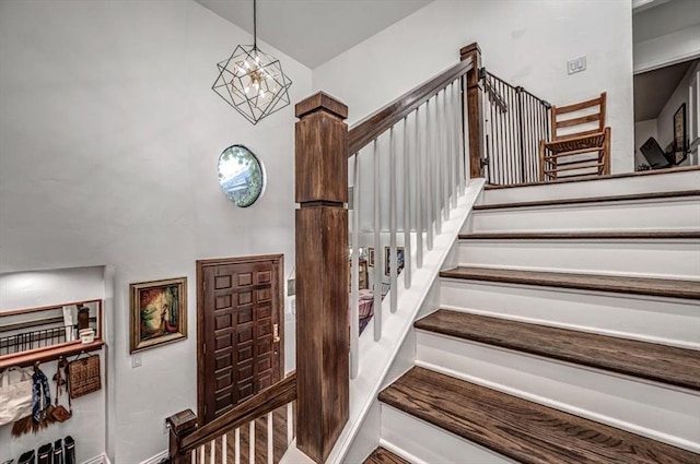 1601 Hazelhurst, Edmond, OK 73013 - staircase with a chandelier and a high ceiling