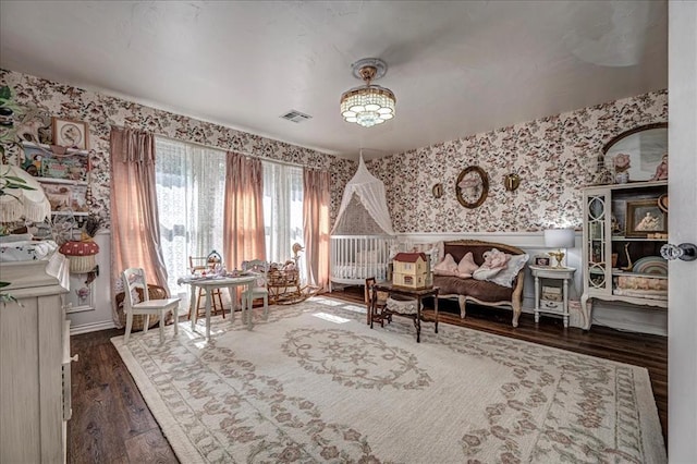 1601 Hazelhurst, Edmond, OK 73013 - living area with wallpapered walls, wood finished floors, and a wainscoted wall