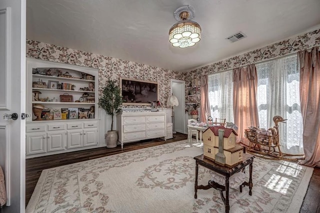 1601 Hazelhurst, Edmond, OK 73013 - living area with dark wood-style floors and wallpapered walls