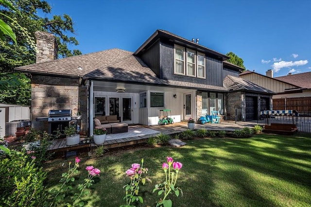 1601 Hazelhurst, Edmond, OK 73013 - rear view of house featuring a chimney, stone siding, a wooden deck, french doors, and an outdoor hangout area