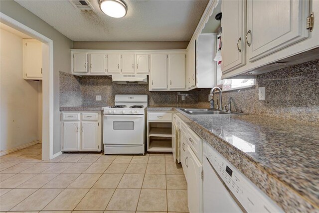 1021 SW 1st St, Moore, OK 73160 - kitchen with white appliances, under cabinet range hood, tasteful backsplash, white cabinetry, and a textured ceiling
