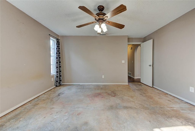 1021 SW 1st St, Moore, OK 73160 - spare room featuring concrete flooring, a ceiling fan, a textured ceiling, and arched walkways