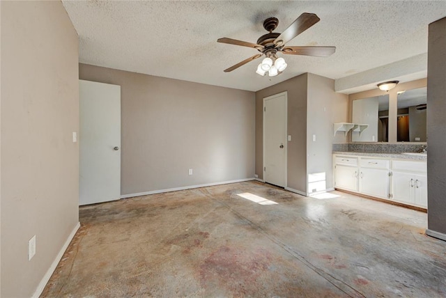 1021 SW 1st St, Moore, OK 73160 - unfurnished bedroom featuring unfinished concrete flooring, a textured ceiling, and a ceiling fan