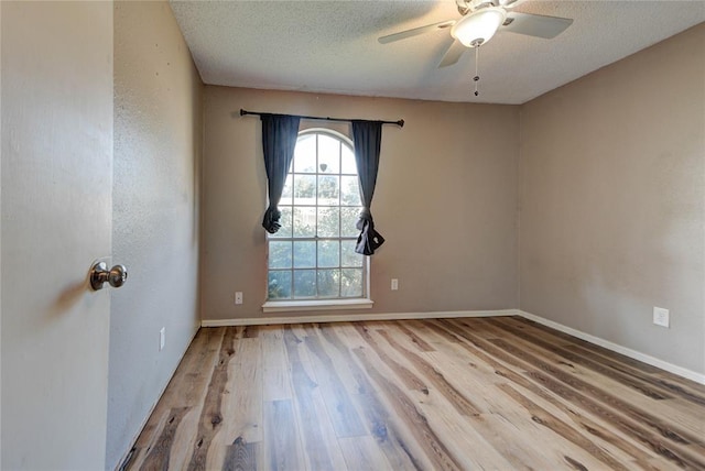 1021 SW 1st St, Moore, OK 73160 - spare room featuring wood finished floors, a textured ceiling, and ceiling fan