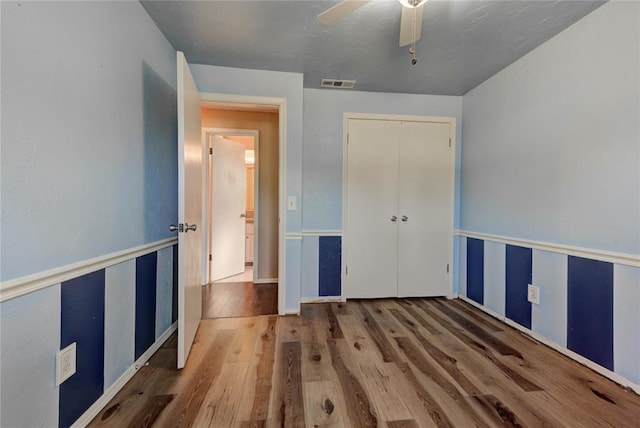 1021 SW 1st St, Moore, OK 73160 - unfurnished bedroom featuring wood finished floors, a closet, and ceiling fan