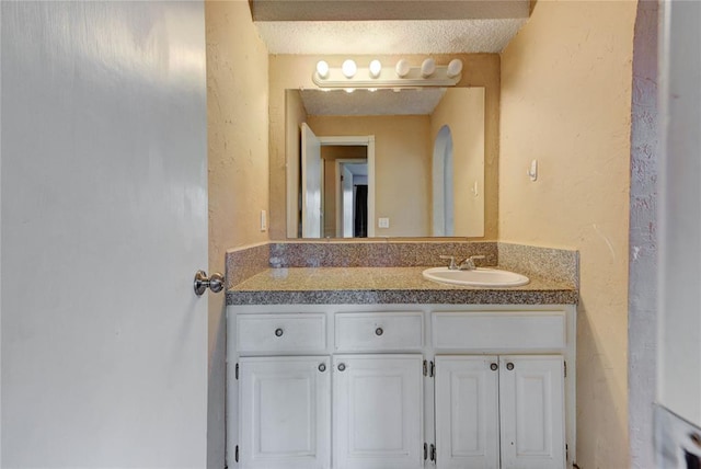 1021 SW 1st St, Moore, OK 73160 - bathroom featuring vanity, a textured wall, and a textured ceiling