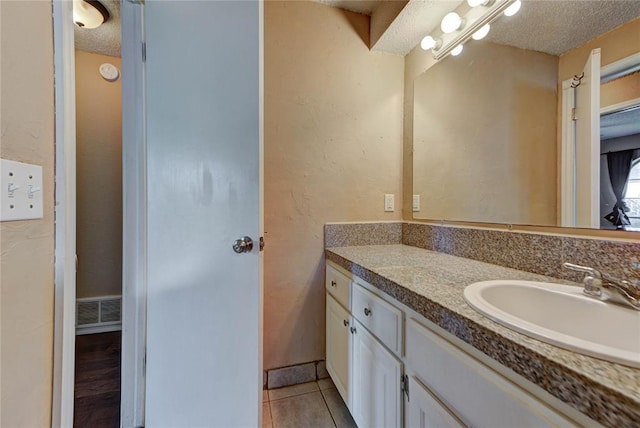 1021 SW 1st St, Moore, OK 73160 - bathroom featuring vanity, a textured ceiling, and tile patterned floors