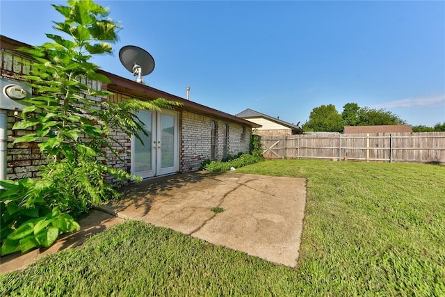 1021 SW 1st St, Moore, OK 73160 - fenced backyard featuring french doors and a patio