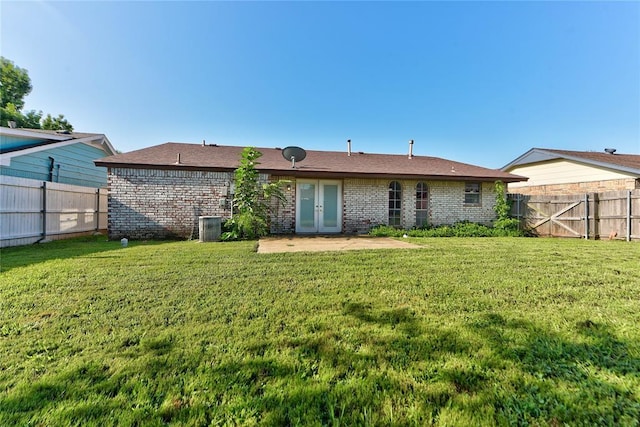 1021 SW 1st St, Moore, OK 73160 - rear view of house with french doors, a patio, a fenced backyard, and brick siding