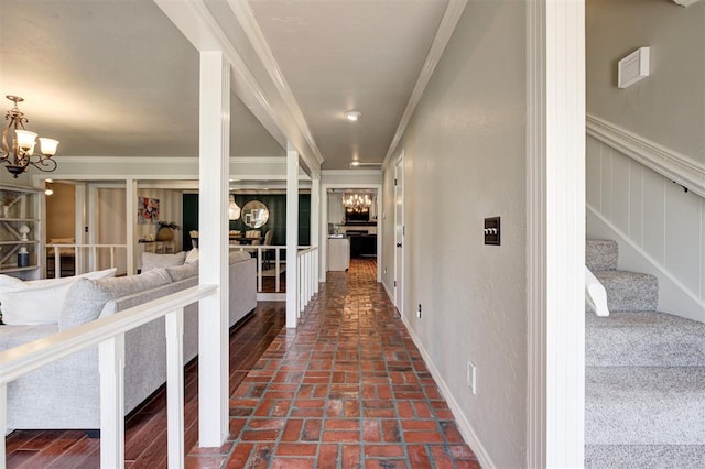 5305 Circle Gln, Edmond, OK 73025 - hall featuring crown molding, a chandelier, brick floors, and stairs