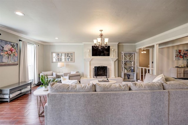 5305 Circle Gln, Edmond, OK 73025 - living area with dark wood-style flooring, a chandelier, crown molding, a high end fireplace, and recessed lighting