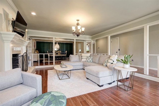5305 Circle Gln, Edmond, OK 73025 - living room with a chandelier, ornamental molding, a high end fireplace, dark wood-style floors, and recessed lighting