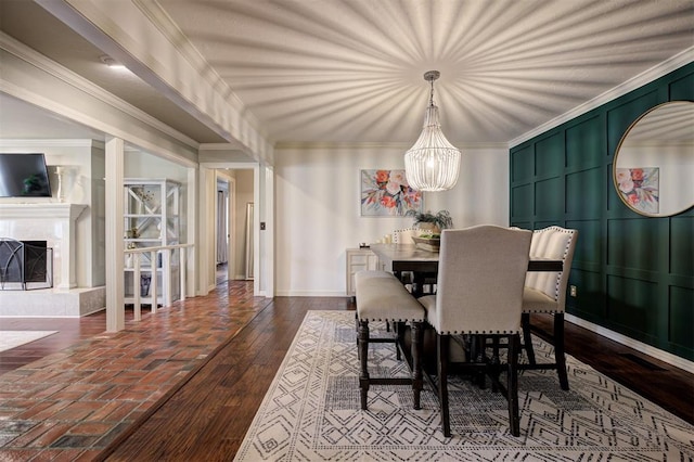 5305 Circle Gln, Edmond, OK 73025 - dining area with a chandelier, a fireplace, and crown molding