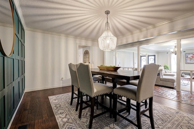 5305 Circle Gln, Edmond, OK 73025 - dining area featuring a chandelier, dark wood-type flooring, and crown molding