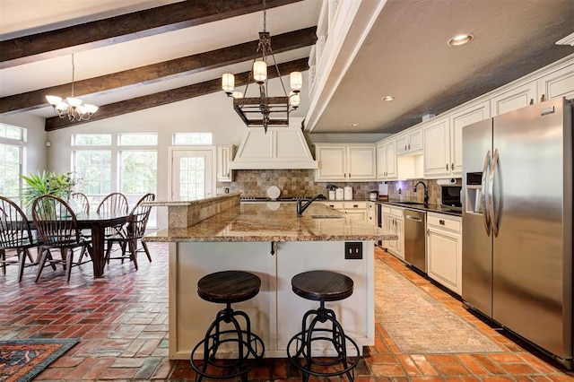 5305 Circle Gln, Edmond, OK 73025 - kitchen featuring stainless steel appliances, a chandelier, tasteful backsplash, a kitchen bar, and recessed lighting