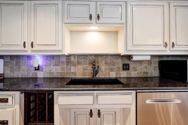 5305 Circle Gln, Edmond, OK 73025 - kitchen featuring stainless steel dishwasher, backsplash, dark stone countertops, and white cabinets