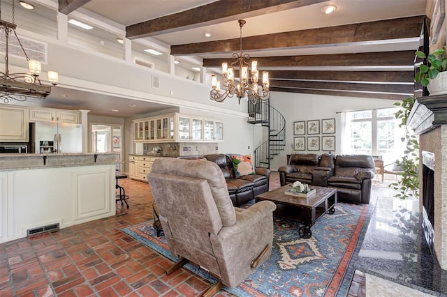 5305 Circle Gln, Edmond, OK 73025 - living area featuring a chandelier, stairway, beamed ceiling, brick floors, and a fireplace