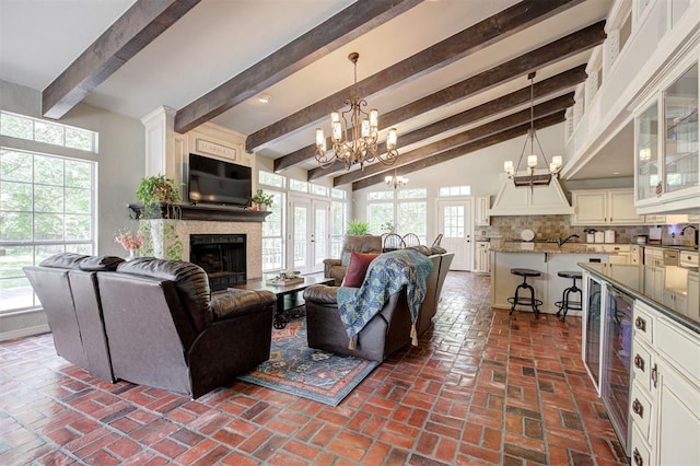 5305 Circle Gln, Edmond, OK 73025 - living area with a chandelier, brick floors, a fireplace, and wine cooler