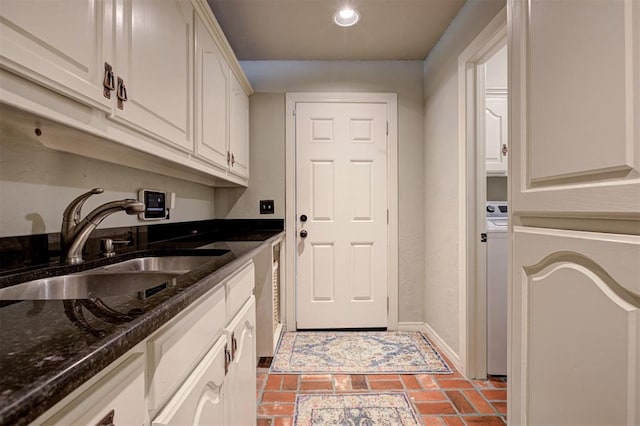 5305 Circle Gln, Edmond, OK 73025 - kitchen with white cabinetry, recessed lighting, dark stone counters, brick patterned flooring, and washer / clothes dryer